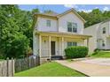 Charming two-story home with a covered front porch and fresh landscaping at 55 Bowen Ave, Atlanta, GA 30315