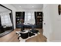 Stylish office with a large mirror, hardwood floors, built-in bookshelves, and modern decor at 13 Highland Park Ne Ln, Atlanta, GA 30306