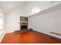 Bright living room featuring vaulted ceiling, wood floors, and a cozy stone fireplace at 134 Timber Creek Sw Ln, Marietta, GA 30060