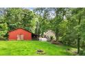 Expansive backyard featuring a red barn and lush green lawn, perfect for outdoor activities and enjoying nature at 265 Shane Dr, Canton, GA 30115