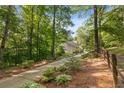 Beautiful house surrounded by a fence and lush trees, with a long driveway offering privacy and seclusion at 265 Shane Dr, Canton, GA 30115