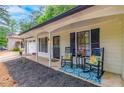 Inviting front porch with rocking chairs, plants, and a decorative wreath on the front door at 2038 Summertown Dr, Norcross, GA 30071