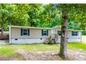 Exterior view of home featuring vinyl siding, black shutters and wood porch and stairs at 300 Old Boy Scout Rd, Whitesburg, GA 30185