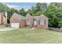 Beautiful brick home with manicured lawn and a two-car garage with ample parking at 1258 Rocky Branch Trl, Lawrenceville, GA 30043