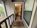 Cozy entryway featuring a welcome mat, visible living area, and natural light streaming through a window at 3915 Woodridge Way, Tucker, GA 30084