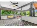 Relaxing screened patio with a ceiling fan, swing, and an outdoor rug, creating a cozy retreat at 1630 Park Ln, Marietta, GA 30066