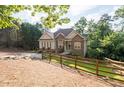 Beautiful exterior view of the home, showcasing its well-maintained yard and mature trees at 1745 Habersham Marina Rd, Cumming, GA 30041