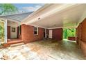 Attached brick carport with entry doors and a solid roof provides ample parking and shelter at 3080 Lynhurst Cir, Atlanta, GA 30311