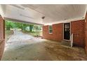 Spacious covered carport offering protection with brick column supports and access to the home's entry at 3080 Lynhurst Cir, Atlanta, GA 30311