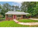 All brick home with a striking red front door and large windows at 3080 Lynhurst Cir, Atlanta, GA 30311