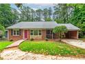 Inviting brick home with lush lawn, complemented by a covered carport at 3080 Lynhurst Cir, Atlanta, GA 30311