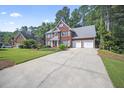 Beautiful two-story brick home with a long driveway and attached two-car garage at 4525 Cavallon Nw Way, Acworth, GA 30101