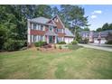 Inviting two-story home featuring a brick facade, well-maintained lawn, and two-car garage at 4525 Cavallon Nw Way, Acworth, GA 30101