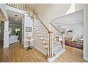 Elegant foyer with hardwood floors and a staircase leading to the upper level at 4525 Cavallon Nw Way, Acworth, GA 30101