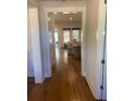 Open-concept living room with hardwood floors and abundant natural light from two windows at 203 Belmont Park Dr, Canton, GA 30115