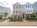 Charming townhouse featuring a brick facade, inviting entrance, and meticulously manicured landscaping at 361 Watson Ave, Woodstock, GA 30189
