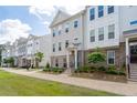 Charming townhomes boast inviting entrances, brick accents, and manicured landscaping, creating an attractive curb appeal at 361 Watson Ave, Woodstock, GA 30189