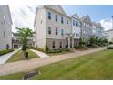 Attractive townhomes with manicured lawns and brick sidewalks in a well-maintained community at 361 Watson Ave, Woodstock, GA 30189