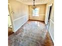 A dining room featuring a single window for natural lighting and vintage hardwood flooring at 1386 Bluefield Sw Dr, Atlanta, GA 30310