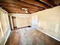 Spacious living room with exposed ceiling, and original hardwood flooring throughout at 1386 Bluefield Sw Dr, Atlanta, GA 30310