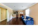 Cozy living room featuring dark hardwood floors, crown molding, and a bright window at 3220 Memorial Dr, Decatur, GA 30032