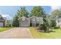 Charming two-story home featuring a well-manicured lawn, two-car garage, and a welcoming front entrance at 3830 Gallant Fox Ct, Duluth, GA 30096