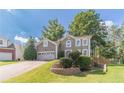 Charming two-story home featuring a well-manicured lawn, two-car garage, and a welcoming front entrance at 3830 Gallant Fox Ct, Duluth, GA 30096