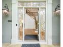 Elegant front door with decorative glass panels and sidelights, offering a glimpse of the staircase at 265 Landfall Rd, Atlanta, GA 30328