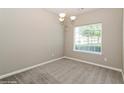 Cozy dining area featuring a chandelier and a large window for natural light at 5612 Festival Ave, Fairburn, GA 30213