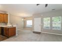 Bright living room adjacent to kitchen featuring neutral paint and abundant natural light at 5612 Festival Ave, Fairburn, GA 30213