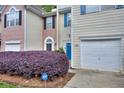 Exterior view showing the townhome's facade, garage, and well-kept landscaping at 5640 Terremont Cir, Norcross, GA 30093