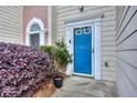 Bright blue front door with decorative trim and surrounding landscape at 5640 Terremont Cir, Norcross, GA 30093
