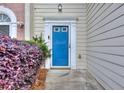 Close-up of the front door and manicured landscaping outside of the home at 5640 Terremont Cir, Norcross, GA 30093