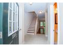Inviting entryway with tiled floor and a staircase leading to the upper level at 1215 Harris Commons Pl, Roswell, GA 30076
