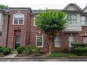 Brick townhome featuring a well maintained landscaped yard at 1215 Harris Commons Pl, Roswell, GA 30076