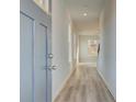 Bright entryway with a blue front door and light wood-look floors at 349 Heavenly Hollow Pl, Mcdonough, GA 30253