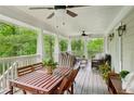 Spacious covered porch with a dining table, ceiling fans, and comfortable seating for outdoor enjoyment at 443 Lakeshore Ne Dr, Atlanta, GA 30307