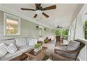 Relaxing covered porch boasts comfortable seating, ceiling fans, and views of the green landscape at 443 Lakeshore Ne Dr, Atlanta, GA 30307