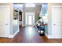 Welcoming foyer with hardwood floors, stylish decor, and a view of the staircase at 109 Lighthorse Blvd, Mcdonough, GA 30252