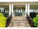 Inviting front porch with stone steps and decorative columns, enhancing curb appeal at 109 Lighthorse Blvd, Mcdonough, GA 30252