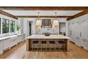 Modern kitchen featuring an island with a marble countertop, bar stools, and stainless steel appliances at 258 Pineland Nw Rd, Atlanta, GA 30342