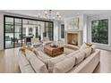 Elegant living room with a fireplace, neutral furniture, and sliding glass doors to the backyard at 258 Pineland Nw Rd, Atlanta, GA 30342