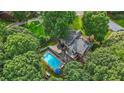 Aerial view of a home with a private pool, multiple decks, and mature trees at 2666 Peachtree Walk, Duluth, GA 30096