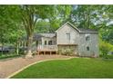 Attractive two-story home with stone accents, a front porch, and mature trees at 2666 Peachtree Walk, Duluth, GA 30096