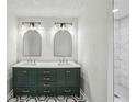Modern bathroom with double vanity, marble countertops, striking black and white tile and tiled shower at 2201 Logan Dr, Jonesboro, GA 30236