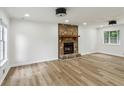 Bright living room with hard wood flooring, stone fireplace and lots of natural light at 2201 Logan Dr, Jonesboro, GA 30236
