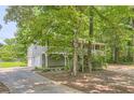 Features a two-car garage and private setting surrounded by lush trees and an oversized driveway at 62 Sweetwater Pkwy, Powder Springs, GA 30127