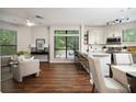 Open-concept kitchen with stainless appliances, breakfast bar, and adjacent living area with large windows at 821 Ralph Mcgill Ne Blvd # 2219, Atlanta, GA 30306