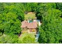 Overhead shot of estate home with pool, cabana, manicured lawn and driveway at 1385 Northcliff Trce, Roswell, GA 30076