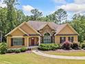 Charming one-story home with stone accents, manicured landscaping, and a welcoming walkway at 212 Wilshire Ter, White, GA 30184
